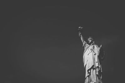 Low angle view of statue against sky