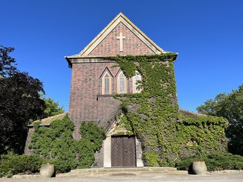 Low angle view of historic building against clear blue sky