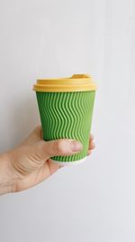 Paper cup of coffee in hand