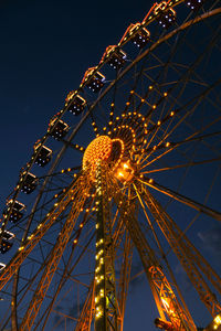 Ferris wheel lights at night. neon colored lights flashing on the ferris wheel. amusement park 