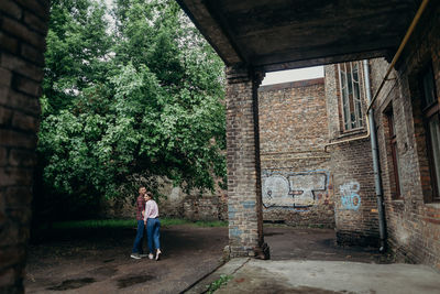 Full length of man standing by wall in building