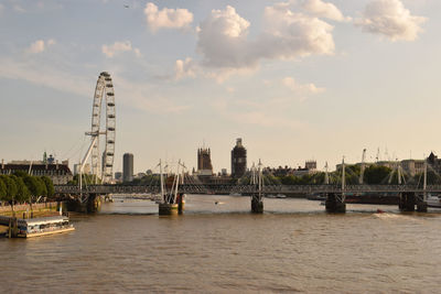 View of bridge over river against cloudy sky