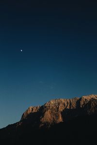 Low angle view of rocks against sky at night