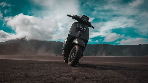 Horse riding motorcycle on road against sky