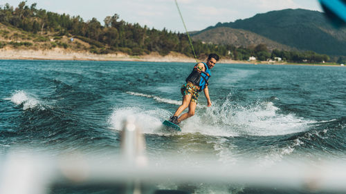 Full length of man doing wakeboard in a lake