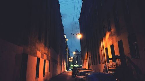 Street amidst buildings in city at night