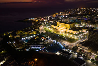 High angle view of illuminated city buildings at night