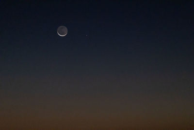 Low angle view of moon against sky at night