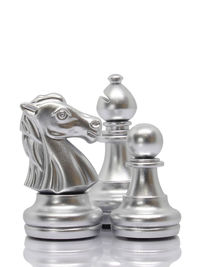 Close-up of chess pieces against white background