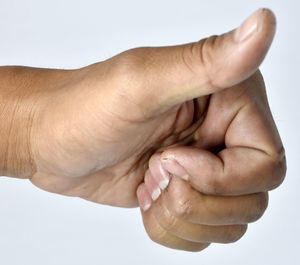 Close-up of hands over white background