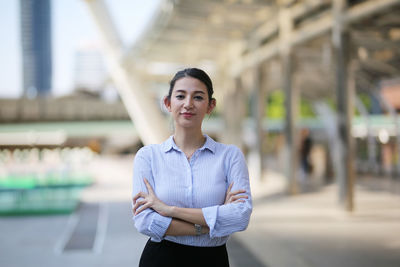 Portrait of a young woman standing outdoors