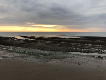 Scenic view of beach against sky during sunset