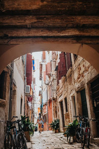 People on street amidst buildings in city