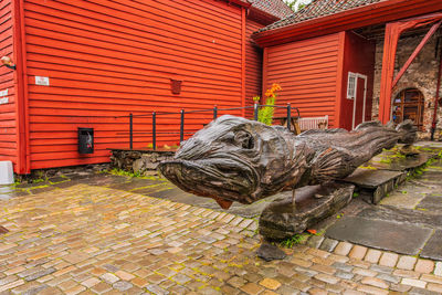 View of an animal statue on footpath against building