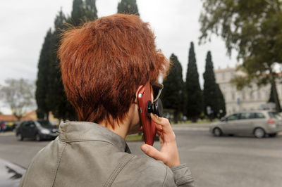 Portrait of man using mobile phone on street
