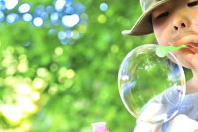 Close-up of girl holding bubble bubbles