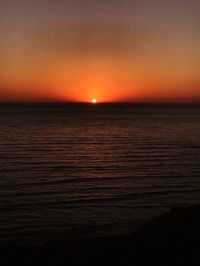 Scenic view of sea against orange sky