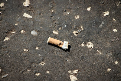 High angle view of cigarette on sand