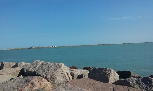 Scenic view of sea against clear blue sky