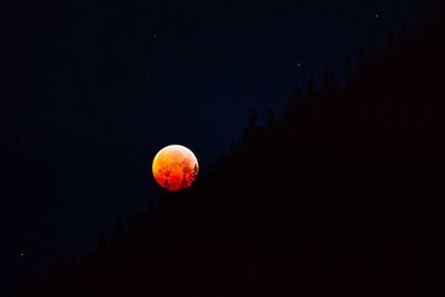 Low angle view of moon against sky at night