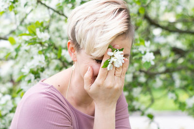 Young woman holding flower