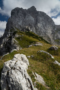 Low angle view of rocks on mountain against sky