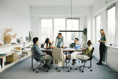 Multiracial business professionals discussing in meeting at office