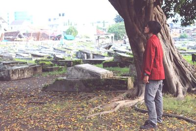 Woman standing by tree