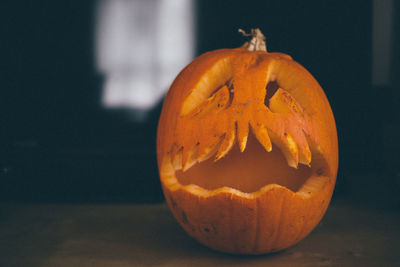 Close-up of pumpkin against orange wall