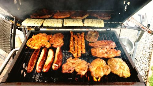 High angle view of meat on barbecue grill