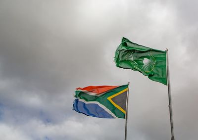 Low angle view of flags flag against sky