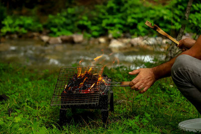 Man preparing food on barbecue grill