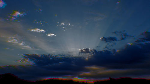 Low angle view of rainbow against sky during sunset