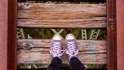 Low section of person standing on railway bridge