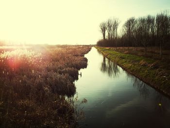 Scenic view of river at sunset