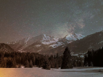 Scenic view of snow covered mountains against sky