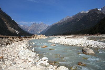 Scenic view of lake and mountains against sky