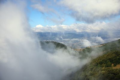 Aerial view of clouds over mountain