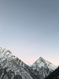 Scenic view of snowcapped mountains against clear sky