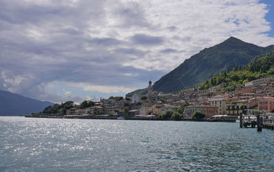 Scenic view of sea and mountains against sky