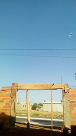 Low angle view of bird against clear blue sky