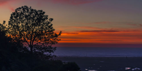 Scenic view of sea against orange sky