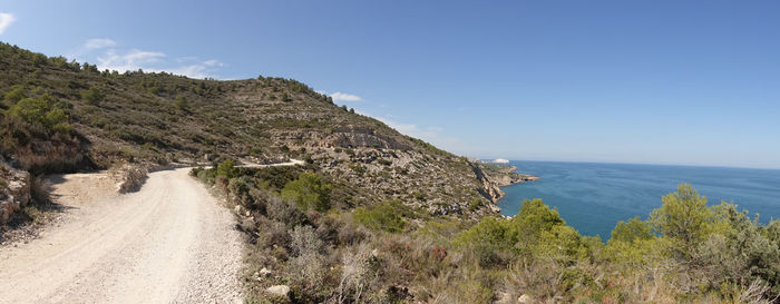 Panoramic view of road by sea against sky