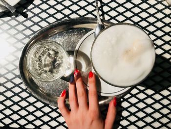 High angle view of woman hand holding drink
