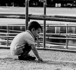 Side view of boy on railroad track