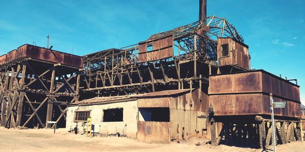 Old abandoned factory against sky