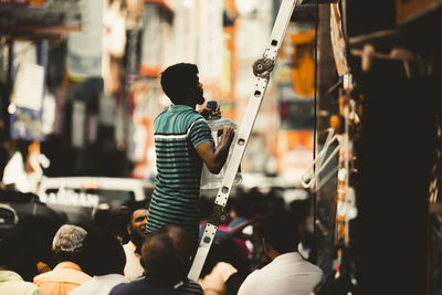 Rear view of man holding guitar