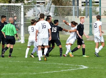 Group of people walking on soccer field