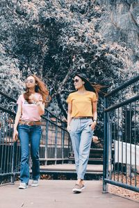 Full length portrait of young couple standing in railing