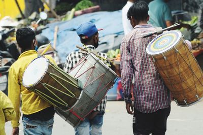 Maestro carrying drums in wedding party